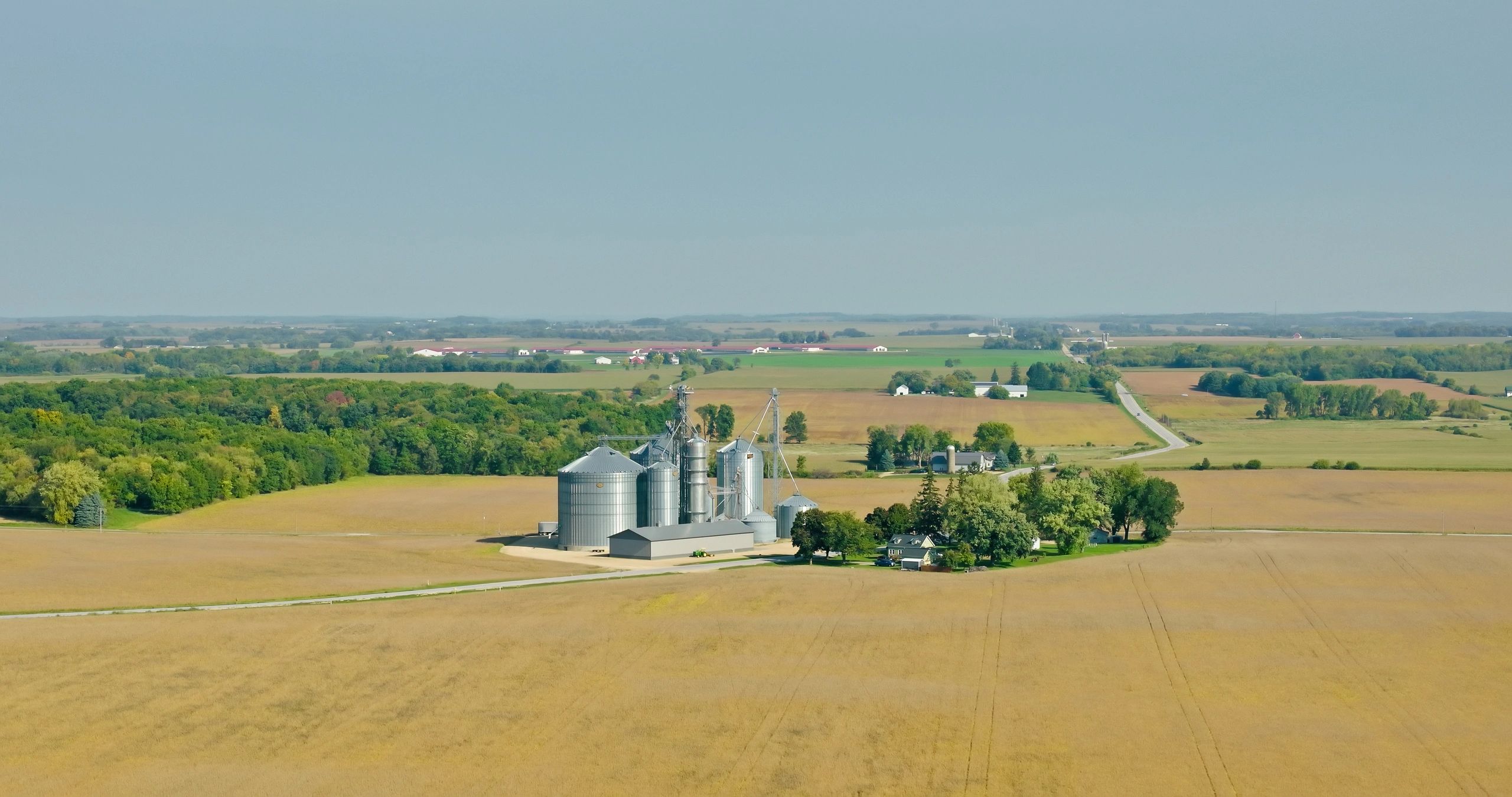 Aerial view of farmland and agricultural buildings
