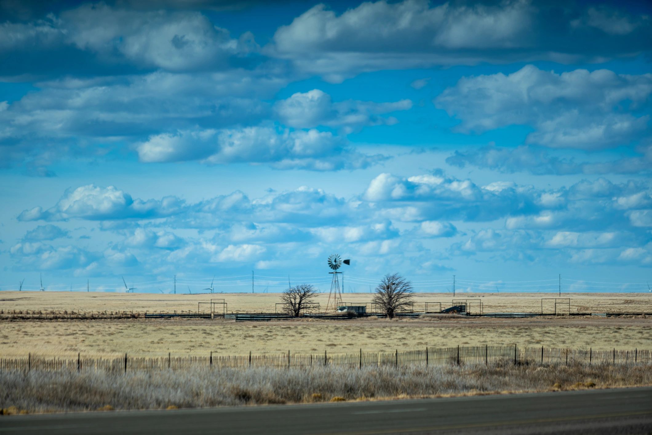 Historic rural farm landscape with windmill and fencing